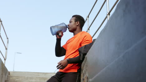 Black-man,-drinking-water-and-fitness-outdoor