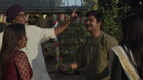 joyful family and friends dancing at an outdoor celebration