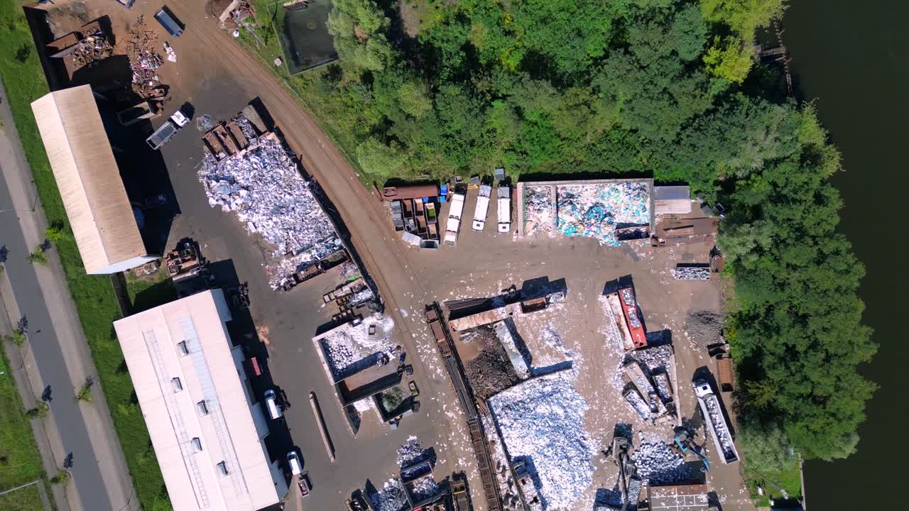scrap metal recycling center managing waste and loading trucks, Hennigsdorf, Germany. Nice aerial view flight overflight flyover drone camera pointing down