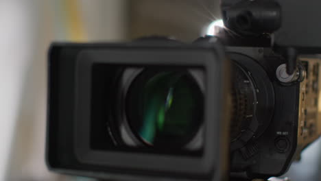 close up of film or video camera on tripod shooting movie or video in studio 3