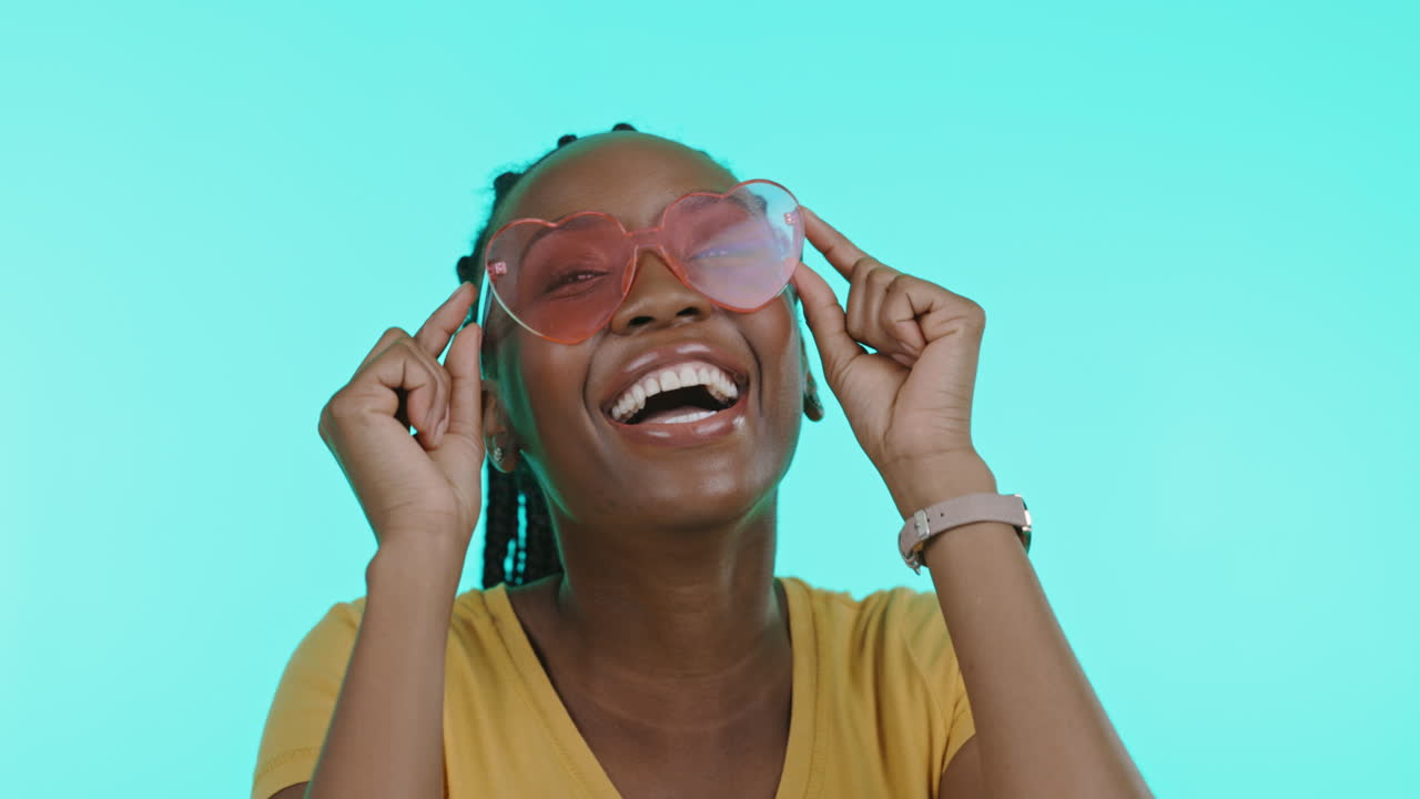 Smiling Woman with Pink Heart-Shaped Sunglasses