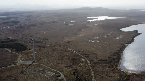 drone shot of a wind turbine at a wind farm generating green, sustainable energy