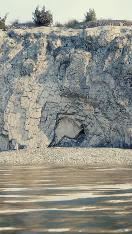 a rocky cliff with a small cave