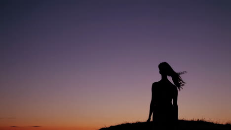 woman silhouetted at sunset