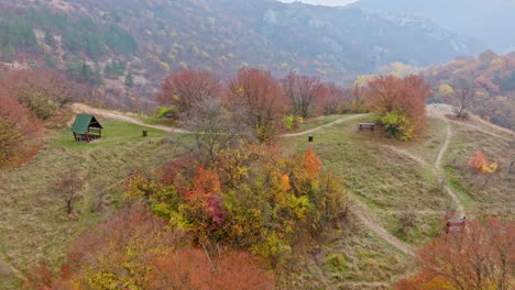 autumn mountain landscape with rustic shelter and picnic area