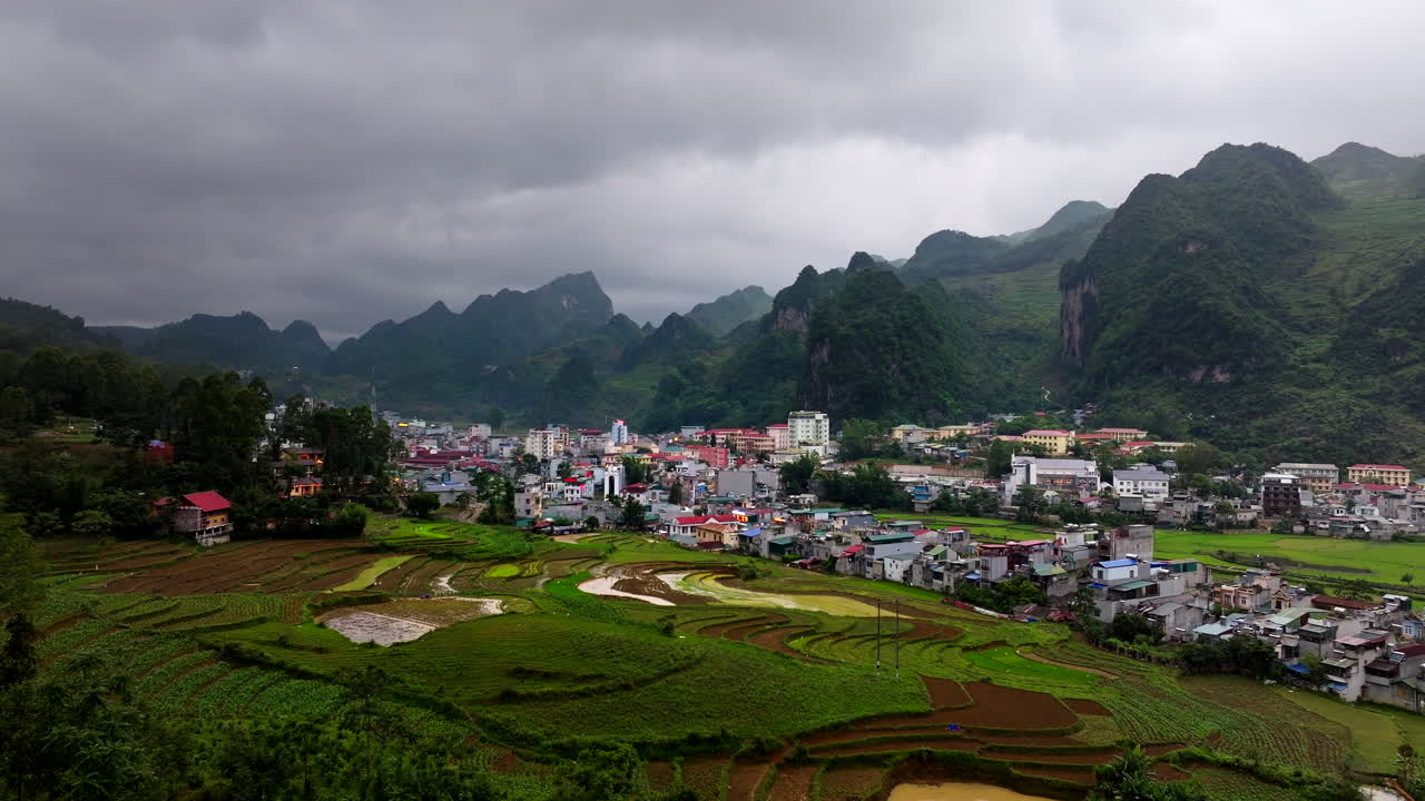 Dong Van town in North Vietnam surrounded by rice fields and mountains, aerial