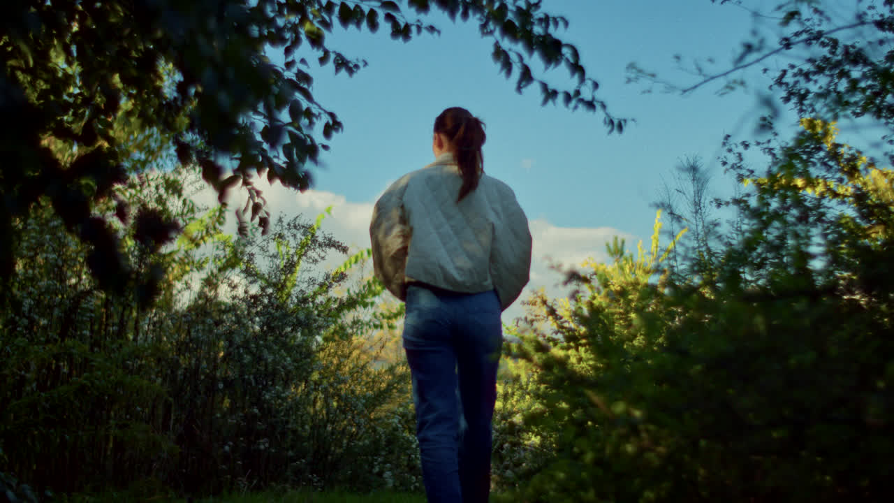 Woman Exploring a Forest Path