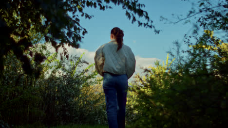 woman exploring a forest path