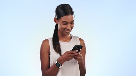 Woman,-texting-and-reading-with-phone-in-studio