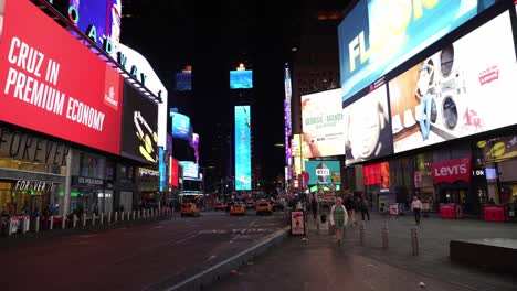 wide angle of times square, showcasing towering skyscrapers and flashing advertisements