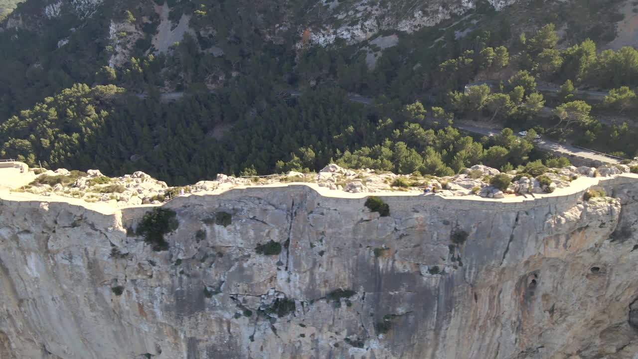 Experience breathtaking aerial perspectives of Mirador es Colomer, showcasing the dramatic cliffs, lush landscapes, and turquoise waters of Pollensa in Mallorca at sunrise.