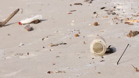 littered beach with plastic waste scattered across the sand, highlighting environmental pollution