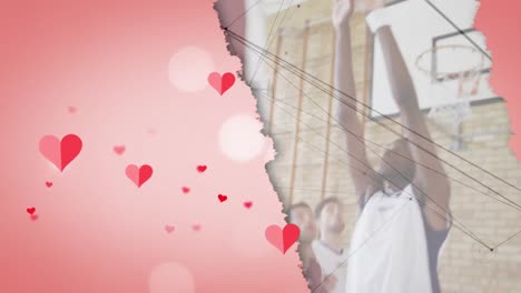 animation of hearts over diverse group of basketball players at gym