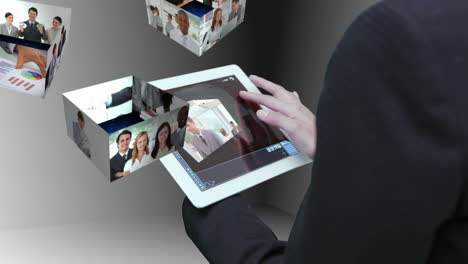 businesswoman using tablet to view montage of business people at work