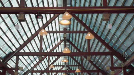 indoor ceiling with wooden beams and hanging lamps