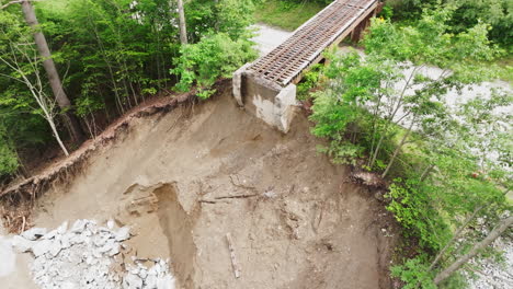 Aerial-Shot-Unveils-Erosion-Halted-Railroad-Tracks-in-Flood-Damaged-Ludlow,-VT