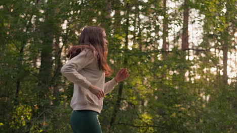 woman running through a forest trail