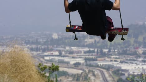 man swinging on rope swing