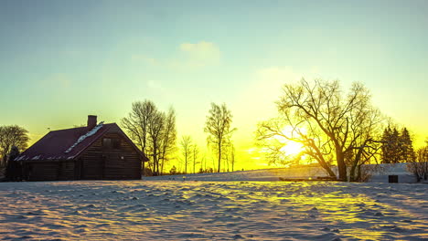 beautiful timelapse of could moving over a house in the morning with the trees in the background and white snow around