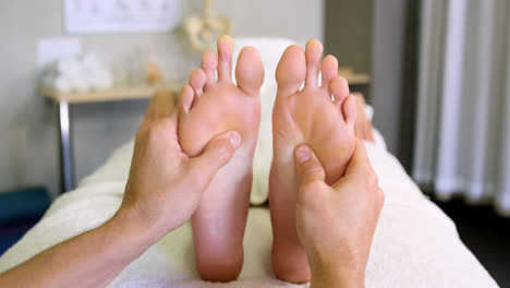 physiotherapist giving foot massage to a woman