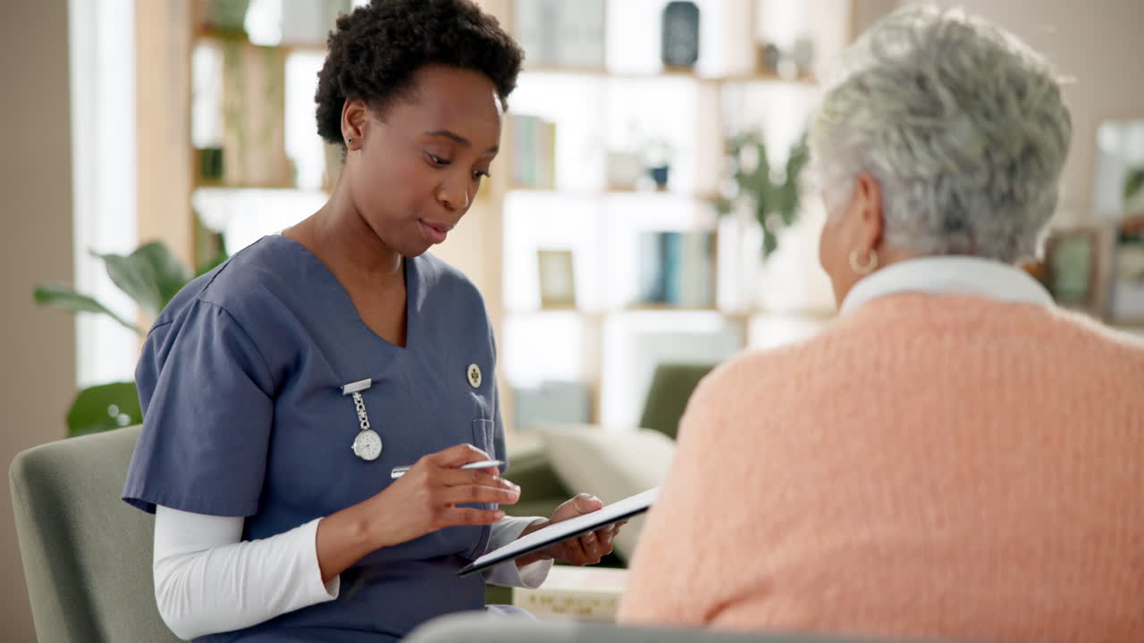 Nurse consulting with elderly patient at home