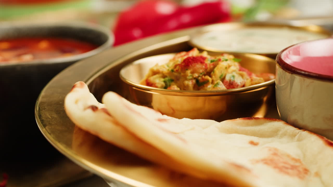 Close-up view of a delicious spicy curry served in a colorful bowl with a spoon, ready for a tasty meal.