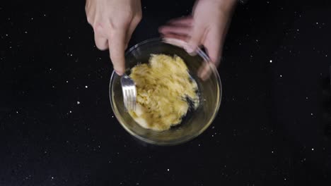 topdown view of mashing banana in a bowl