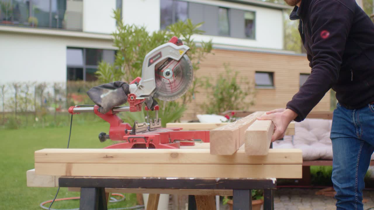 The craftsman putting the wood on the workbench