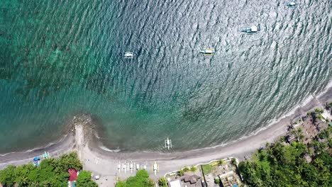 Aerial-view-of-a-little-town-with-sea-in-Negros-Oriental,-Philippines,-during-a-sunny-day