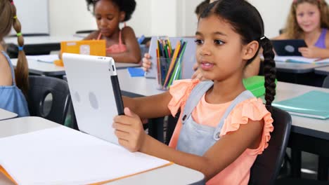 Schoolgirl-using-digital-tablet-in-classroom