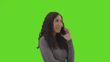 frustrated woman talking on mobile phone against green screen before hanging up 2