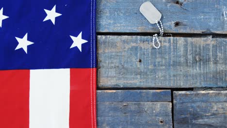 american flag and dog tag on a wooden table