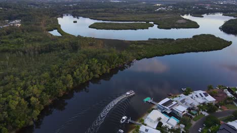 Ferry-Boat-Traveling-Near-The-Accommodation-Structures-At-Noosa-Parade-With-A-View-Of-Ross-Island-And-Weyba-Creek-In-Australia