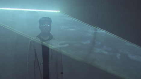 afro-american man standing in dark room with flat sheet of laser light