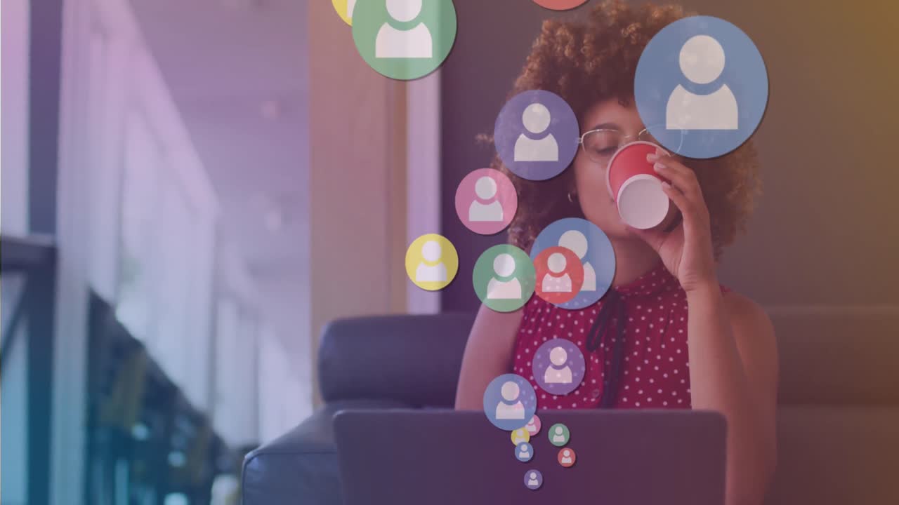 Animação de ícones de mídia sobre empresária birracial com café usando laptop