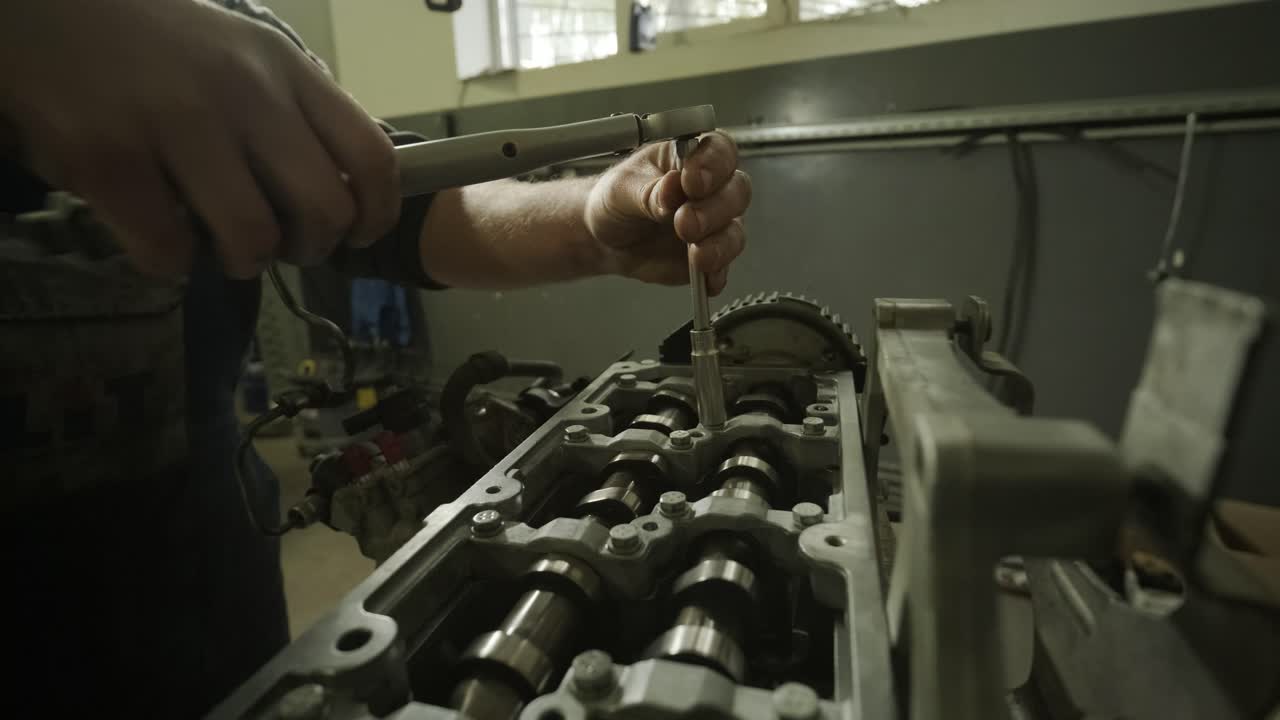 un mecánico de automóviles en un garaje reparando un motor de automóviles después de quitar una cubierta. reparación de motores de automóviles. servicio de automóviles