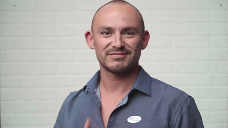 Young-Man-Accepts-Voting-Sticker-and-Puts-it-on-His-Shirt