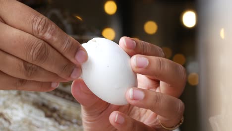 person holding a cracked egg