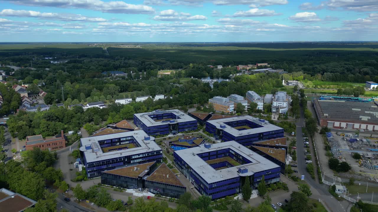 Hennigsdorf, Germany, showcasing residential areas, railway infrastructure and commercial buildings. Great aerial view flight rotation to right drone