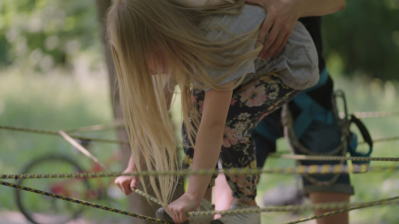 In the summer camp my daughter learns to overcome rope obstacles and rock climbing. Teaching children about tourism and hiking