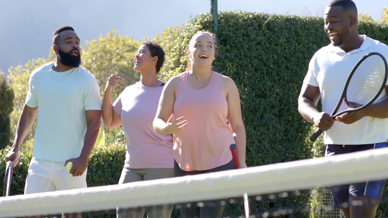 Playing tennis, group of Diverse Friends enjoying outdoor activity on sunny day