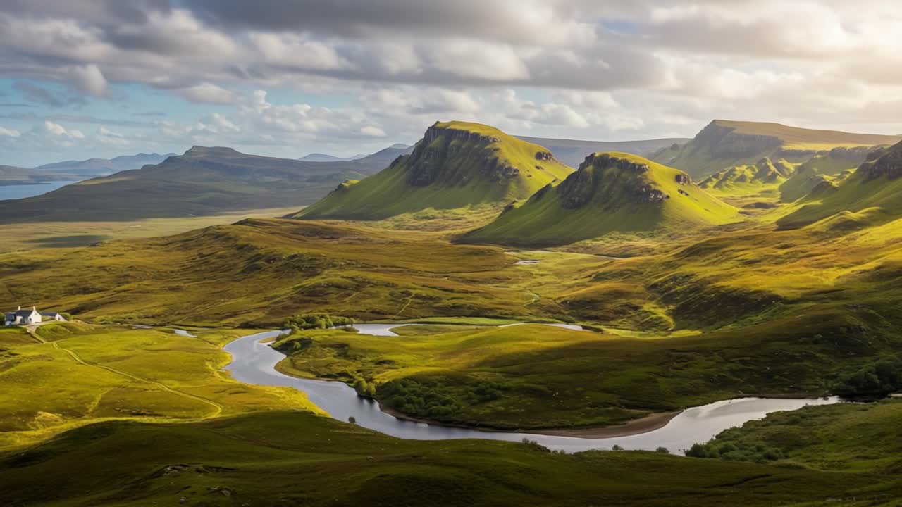 Breathtaking Aerial View of Lush Green Highlands and Serpentine River Under Dramatic Clouds in a Scenic Landscape