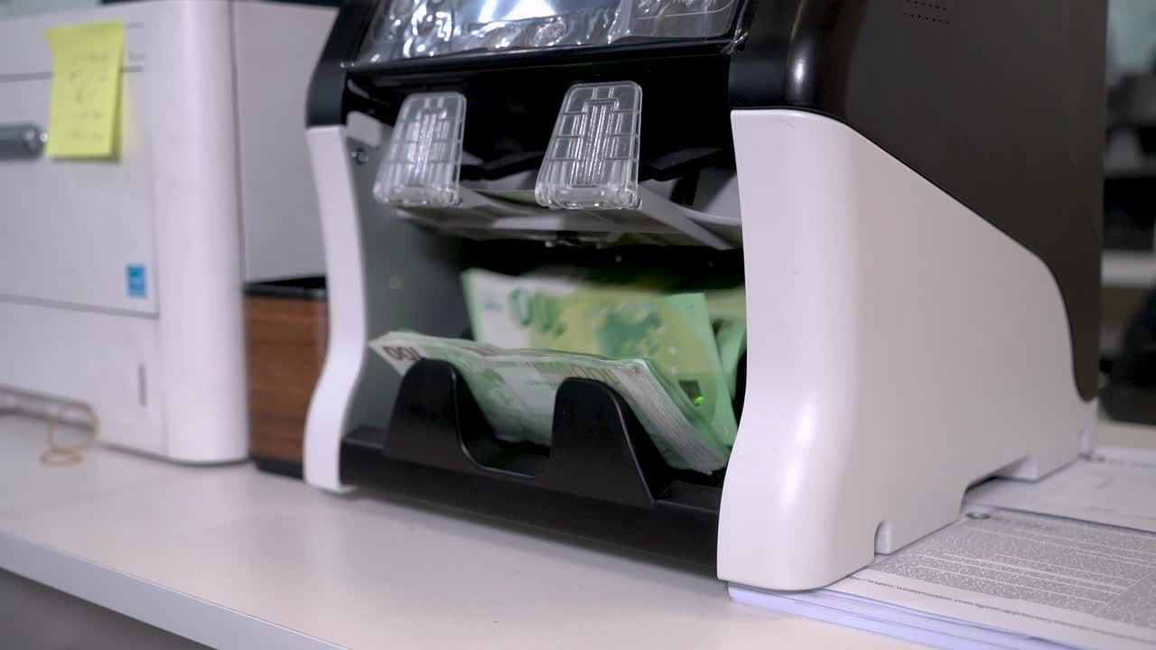 contando billetes de 100 euros en la máquina contadora de divisas