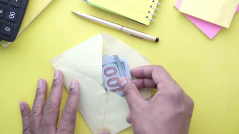 money in an envelope on a desk