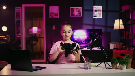 little girl media star filming vr glasses, unboxing them and presenting specifications to gen z fans