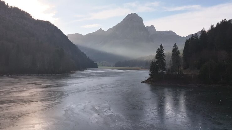 Aerial view of Lake Obersee near Näfels, Switzerland, surrounded by alpine forests and majestic peaks. A serene scene capturing the pristine beauty of the Swiss landscape and tranquil waters.
