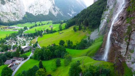 aerial view of lauterbrunnen cityscape waterfall and grass from drone view in switzerland