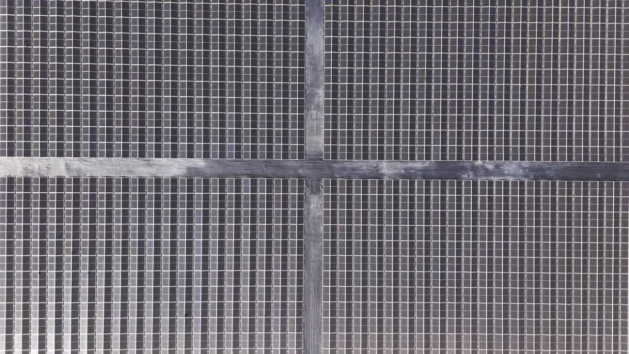 Detailed overhead close-up of solar panel grid lines reflecting sunlight and clean energy technology