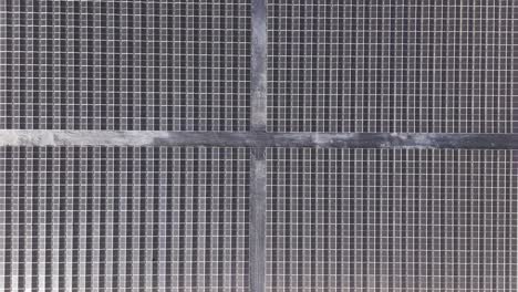 Detailed overhead close-up of solar panel grid lines reflecting sunlight and clean energy technology