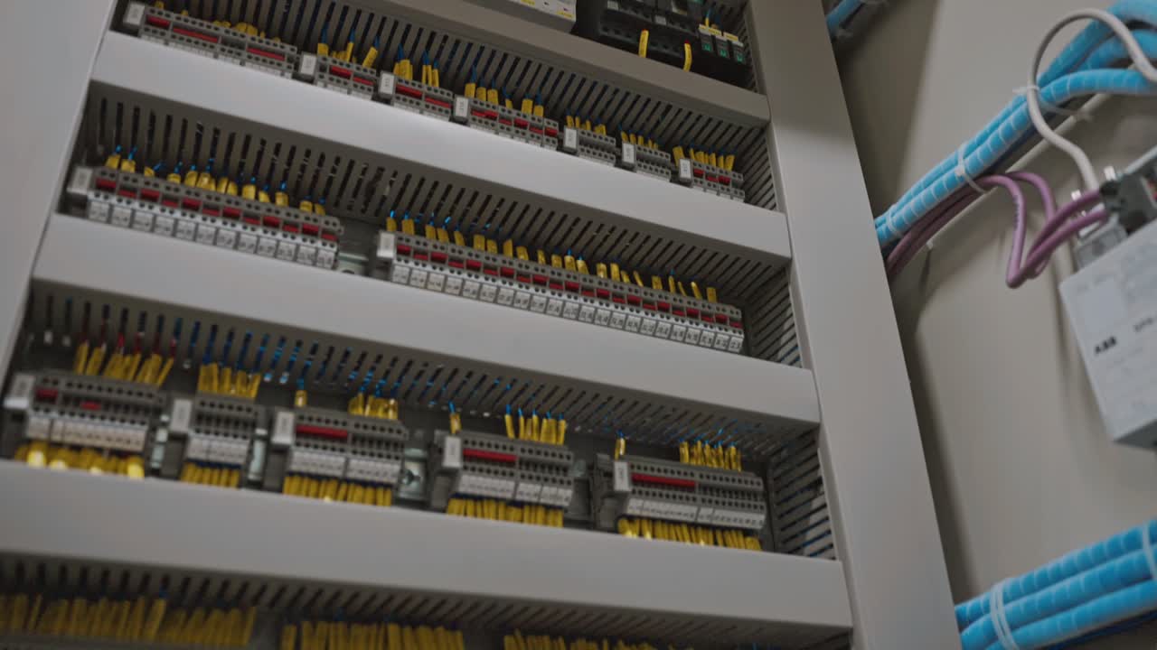Close-up of electrical panel with various breakers and wires